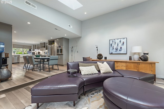 240 Greenridge Dr, Lake Oswego, OR 97035 - living room featuring a skylight, light wood-type flooring, and recessed lighting