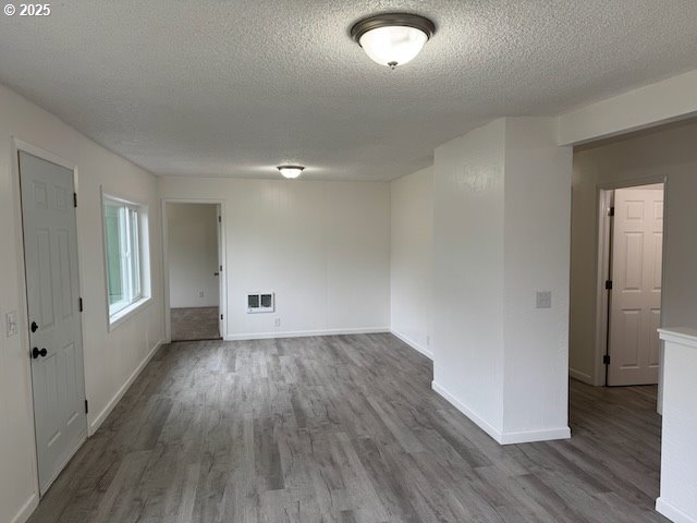 847 NE Jackson Ave, Myrtle Creek, OR 97457 - unfurnished room with wood finished floors, a textured ceiling, and baseboards