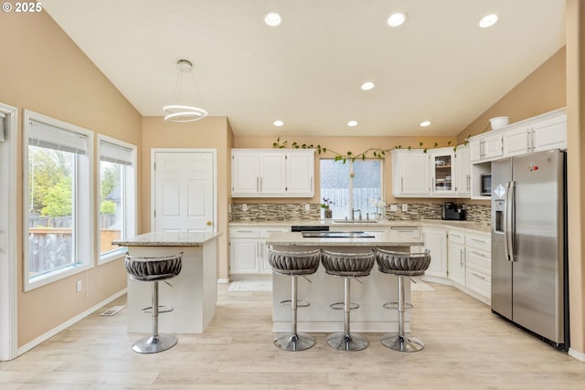 1273 SE Williams Ave, Gresham, OR 97080 - kitchen with stainless steel fridge, decorative backsplash, vaulted ceiling, and a center island