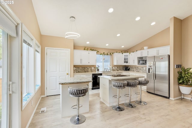 1273 SE Williams Ave, Gresham, OR 97080 - kitchen featuring a center island, decorative backsplash, black appliances, and visible vents
