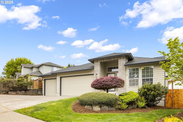 1273 SE Williams Ave, Gresham, OR 97080 - view of front facade with concrete driveway, fence, a shingled roof, and a garage