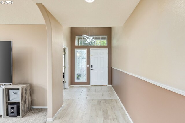 1273 SE Williams Ave, Gresham, OR 97080 - entrance foyer featuring arched walkways, baseboards, a chandelier, and wood finished floors