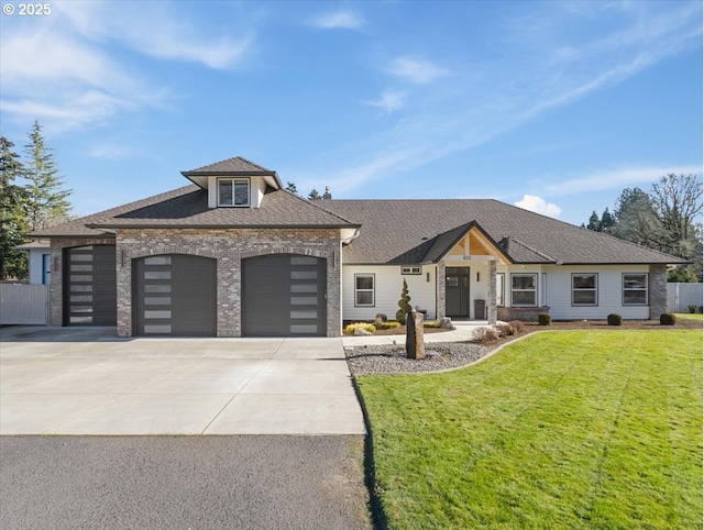 view of front of house featuring a garage and a front lawn