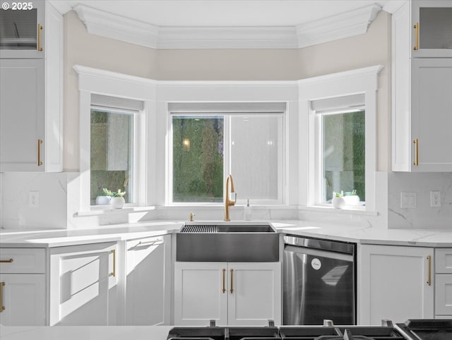 kitchen with sink, tasteful backsplash, stainless steel dishwasher, light stone countertops, and white cabinets