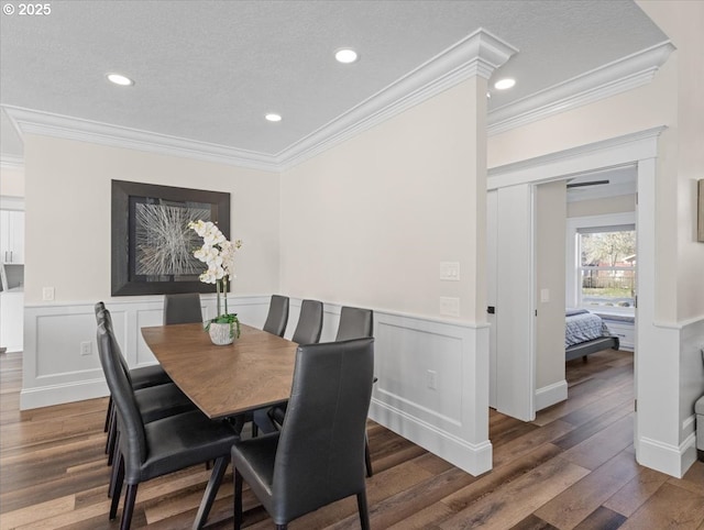 dining space featuring ornamental molding, dark hardwood / wood-style floors, and a textured ceiling