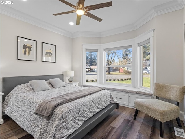 bedroom with crown molding, dark wood-type flooring, and ceiling fan