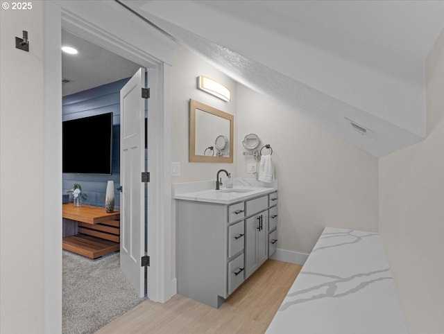 bathroom featuring vanity, hardwood / wood-style floors, and a textured ceiling