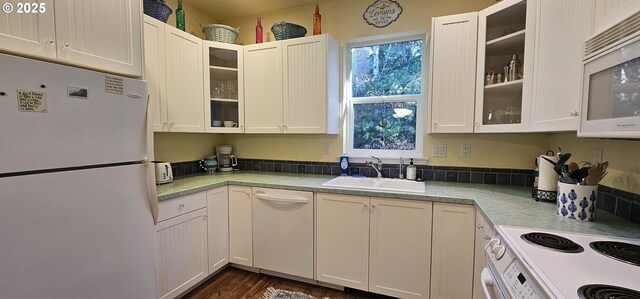 kitchen featuring white cabinetry, dark hardwood / wood-style flooring, sink, and white appliances