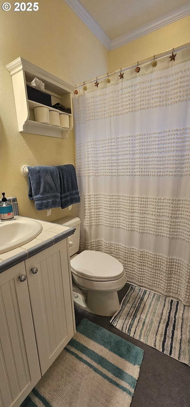 bathroom with vanity, ornamental molding, and toilet