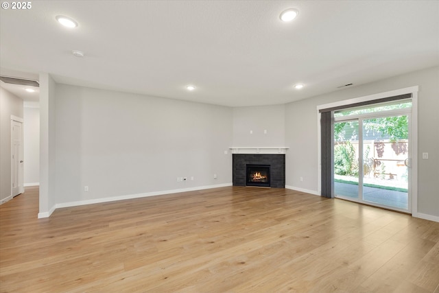 1059 S Walnut St, Canby, OR 97013 - unfurnished living room with recessed lighting, light wood finished floors, a tiled fireplace, and baseboards