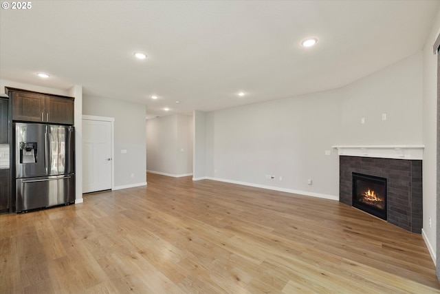1059 S Walnut St, Canby, OR 97013 - unfurnished living room with light wood finished floors, recessed lighting, a fireplace, and baseboards
