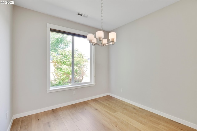 1059 S Walnut St, Canby, OR 97013 - spare room featuring a chandelier, plenty of natural light, light wood-type flooring, and baseboards