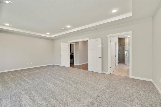 1059 S Walnut St, Canby, OR 97013 - unfurnished bedroom featuring a tray ceiling, carpet flooring, recessed lighting, baseboards, and washer / clothes dryer