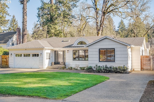 single story home featuring a garage and a front yard