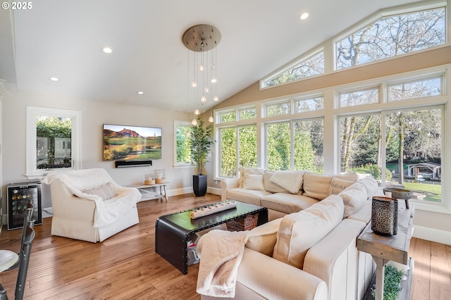 sunroom / solarium featuring vaulted ceiling and a wealth of natural light