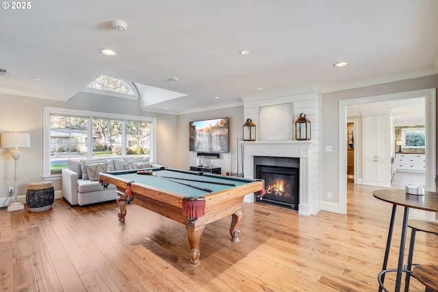 recreation room with billiards, ornamental molding, and light hardwood / wood-style floors