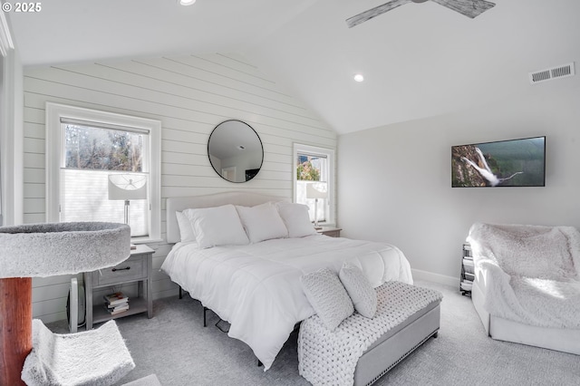 bedroom with multiple windows, lofted ceiling, and light colored carpet