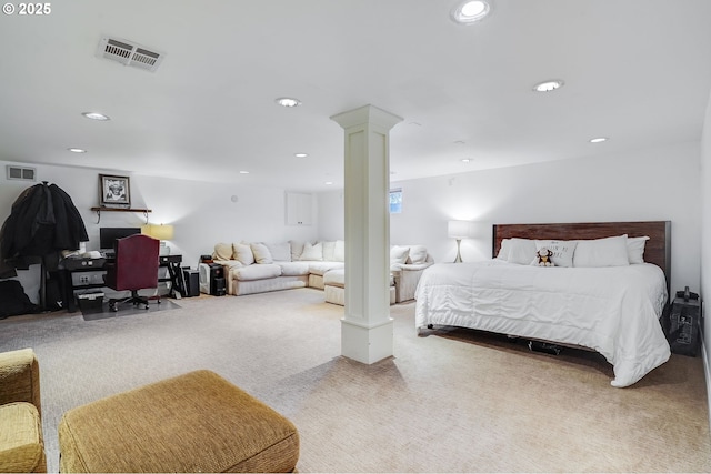 bedroom with decorative columns and carpet flooring