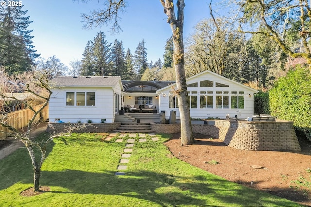 back of house featuring a lawn