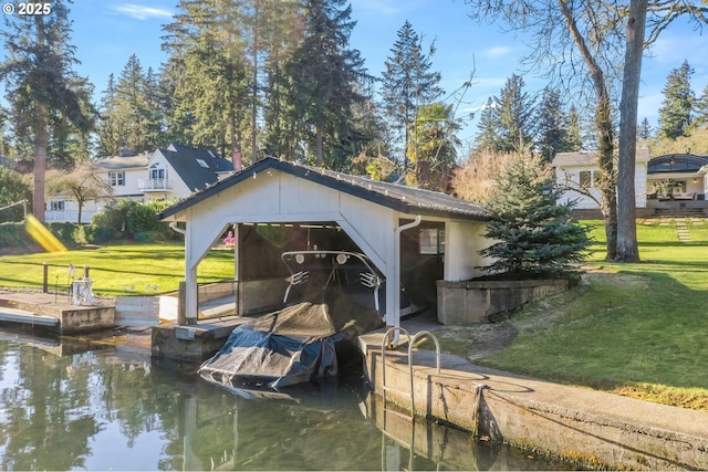 view of dock with a water view and a yard