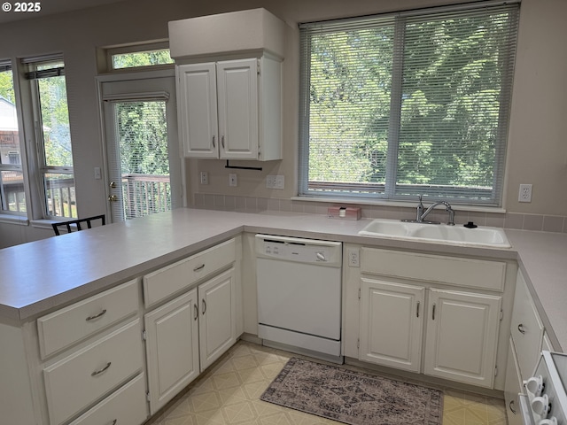 15680 SW Talus Way, Beaverton, OR 97007 - kitchen featuring white dishwasher, a sink, healthy amount of natural light, and a peninsula
