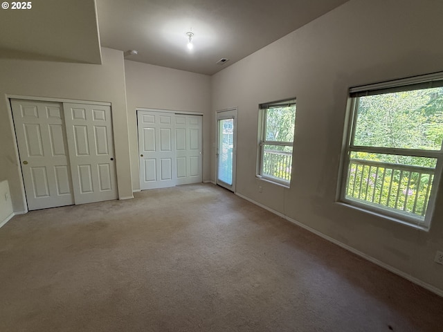 15680 SW Talus Way, Beaverton, OR 97007 - unfurnished bedroom with two closets, baseboards, and carpet flooring
