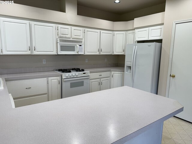 15680 SW Talus Way, Beaverton, OR 97007 - kitchen featuring white appliances, white cabinetry, light countertops, recessed lighting, and a peninsula