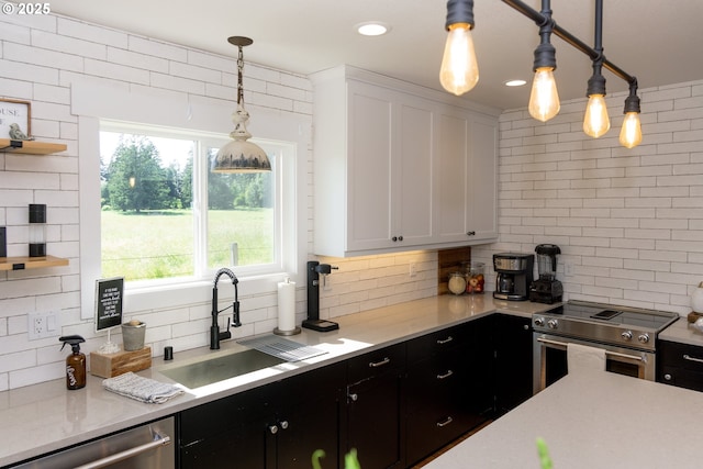 8408 NE 339th St, La Center, WA 98629 - kitchen with appliances with stainless steel finishes, decorative backsplash, light countertops, and dark cabinets