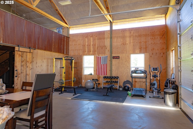 8408 NE 339th St, La Center, WA 98629 - exercise area with healthy amount of natural light, a towering ceiling, and wood walls