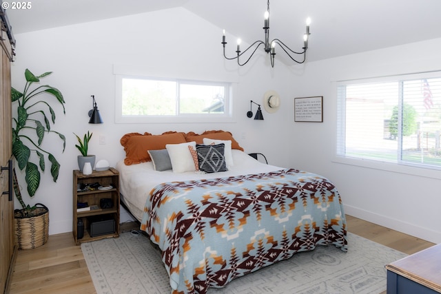 8408 NE 339th St, La Center, WA 98629 - bedroom featuring a chandelier, multiple windows, light wood-style floors, and vaulted ceiling
