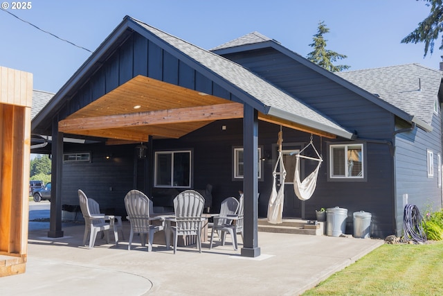 8408 NE 339th St, La Center, WA 98629 - back of property featuring roof with shingles, a patio area, and board and batten siding