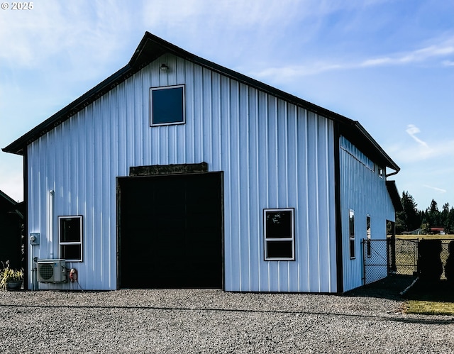 8408 NE 339th St, La Center, WA 98629 - view of property exterior with a pole building, board and batten siding, an outdoor structure, and a detached garage