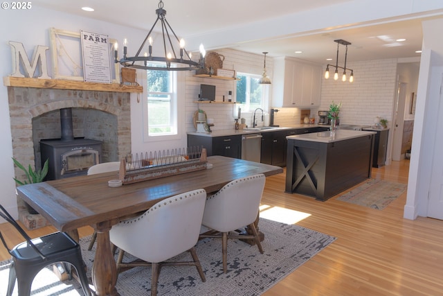 8408 NE 339th St, La Center, WA 98629 - dining area featuring a wood stove, light wood-type flooring, a chandelier, and recessed lighting