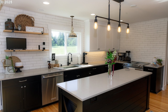 8408 NE 339th St, La Center, WA 98629 - kitchen featuring appliances with stainless steel finishes, dark cabinets, backsplash, light countertops, and open shelves