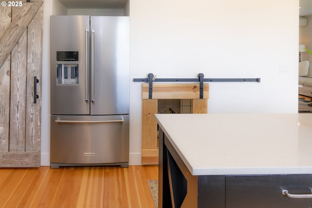 8408 NE 339th St, La Center, WA 98629 - kitchen with high end fridge, light wood-style flooring, and a barn door