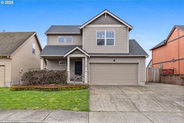 view of front facade featuring a front yard, fence, driveway, roof with shingles, and a garage