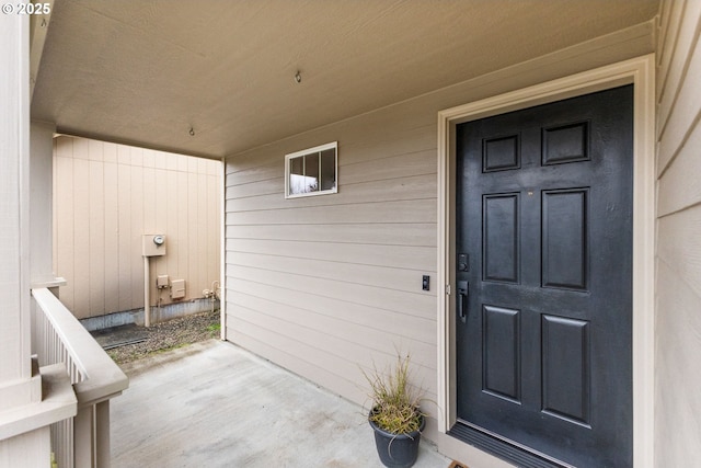 view of exterior entry with covered porch