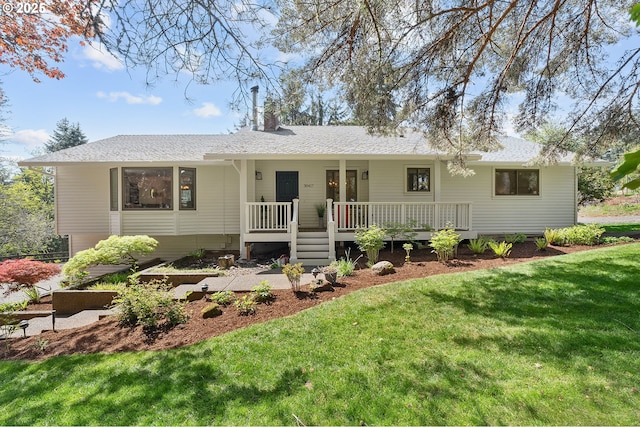 view of front of home featuring a chimney, a front yard, and a wooden deck