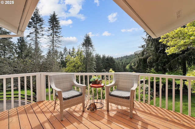 wooden deck featuring a view of trees