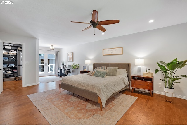 bedroom featuring baseboards, wood-type flooring, recessed lighting, and access to exterior