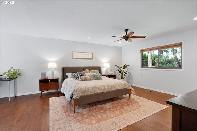 bedroom featuring recessed lighting, baseboards, dark wood finished floors, and a ceiling fan