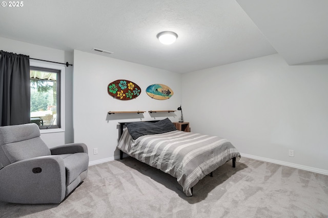 bedroom with baseboards, carpet, a textured ceiling, and visible vents