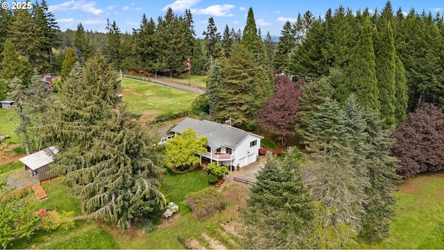 drone / aerial view featuring a wooded view