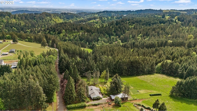 aerial view featuring a forest view and a rural view