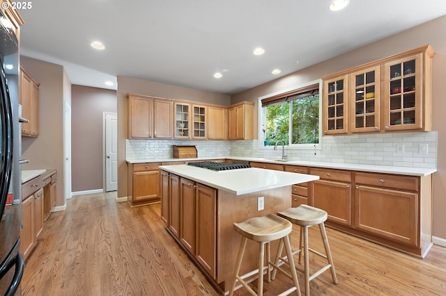 3140 Sabo Ln, West Linn, OR 97068 - kitchen with light wood-style floors, stainless steel gas cooktop, recessed lighting, light countertops, and a sink