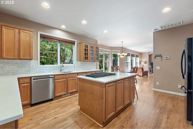 3140 Sabo Ln, West Linn, OR 97068 - kitchen with appliances with stainless steel finishes, a chandelier, recessed lighting, a sink, and decorative backsplash