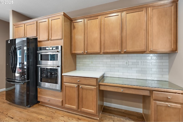 3140 Sabo Ln, West Linn, OR 97068 - kitchen featuring freestanding refrigerator, stainless steel double oven, light wood-style flooring, and tasteful backsplash