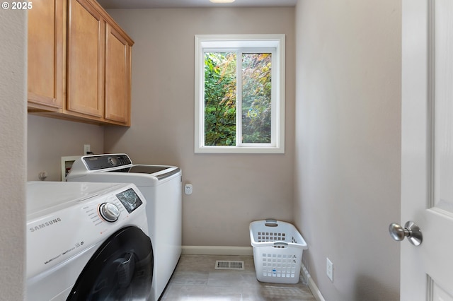 3140 Sabo Ln, West Linn, OR 97068 - laundry area featuring cabinet space, washer and dryer, baseboards, and light tile patterned flooring