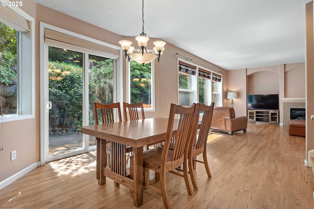 3140 Sabo Ln, West Linn, OR 97068 - dining area with a chandelier, light wood-style flooring, baseboards, and a tile fireplace