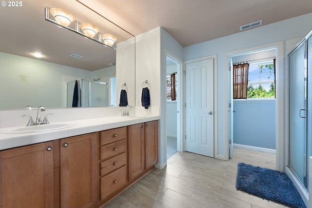 3140 Sabo Ln, West Linn, OR 97068 - bathroom featuring a stall shower, double vanity, baseboards, and tile patterned flooring